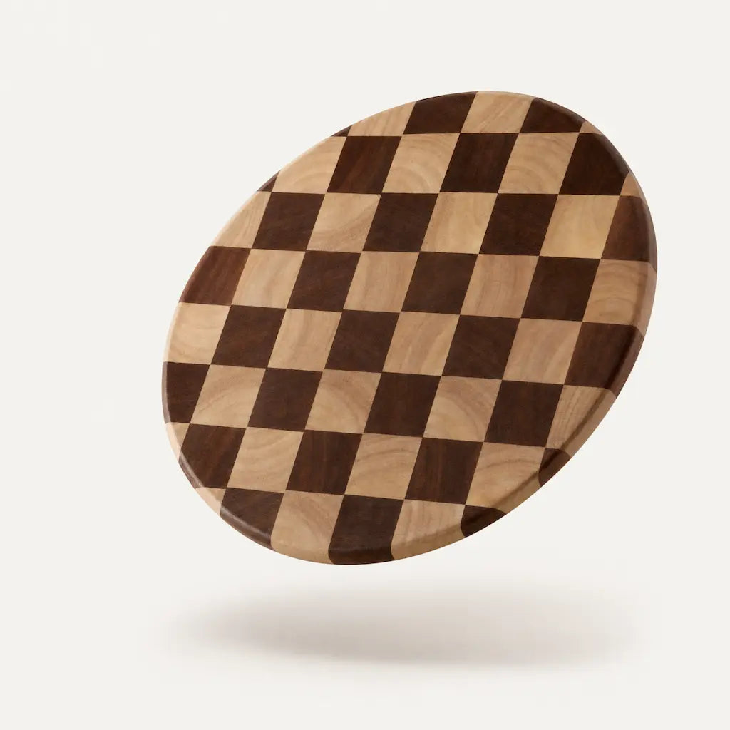 Alorivo round sapele wood checkerboard cutting board, alternating light and dark wood squares crafted from the finest 30% core heartwood, floating on warm white background with soft shadow, premium minimalist product photography.