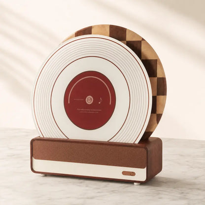 Alorivo vinyl record cutting board set standing upright in wooden base on light marble surface, featuring tempered glass board and sapele wood checkerboard board, refined minimalist kitchen scene with soft natural lighting.