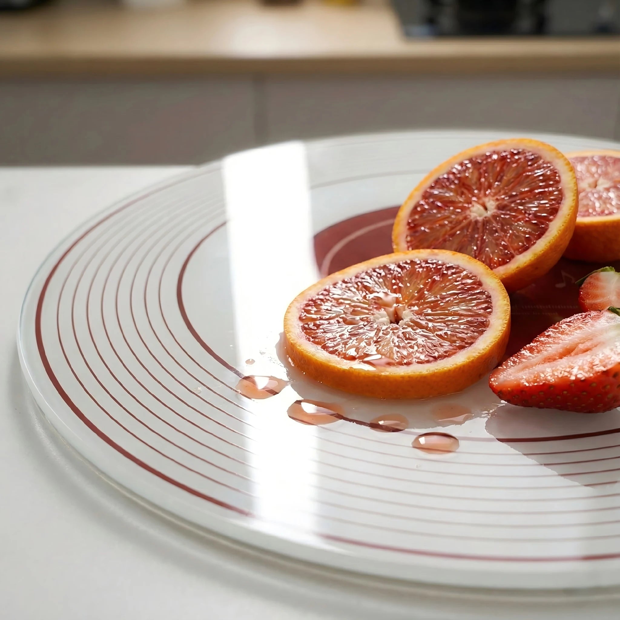 Close-up of Alorivo retro vinyl record design chopping board with fresh fruit, highlighting the hygienic, non-porous tempered glass surface